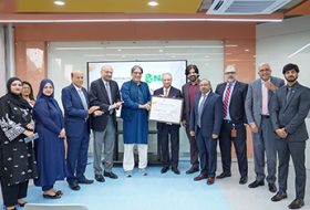 Group photo: Habib University and National Bank of Pakistan leaders hold a framed certificate after signing the scholarship MoU in Karachi.