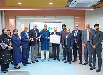 Group photo: Habib University and National Bank of Pakistan leaders hold a framed certificate after signing the scholarship MoU in Karachi.