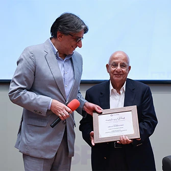 Mr. Abbas D. Habib receiving a certificate on stage at the establishment of the Lady Fatima Zahra Endowed Chair