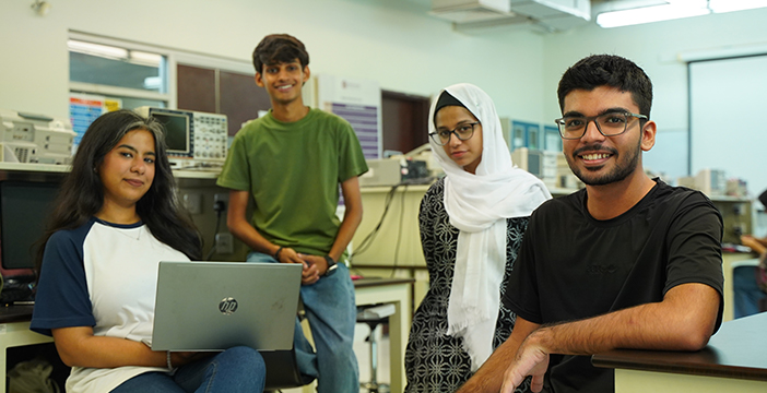 four students posing for the picture